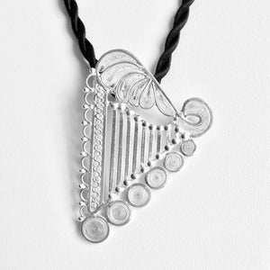 The handmade Luzma Sterling Silver filigree harp pendant is 2 7/16" tall (6.2 cm). You may wear it with your favorite chain, cord, or a color silk ribbon to match or contrast you clothing. Observe the exquisite and intricate filigree details.  Match with filigree earrings.
